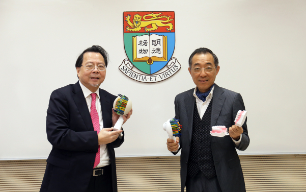 Dr T.C. Ng (left) and Professor L.J. Jin with NJ Toothbrush  